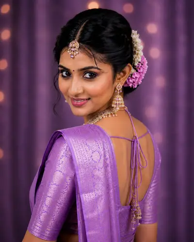 Bride in purple silk saree with temple jewelry and professional bridal makeup